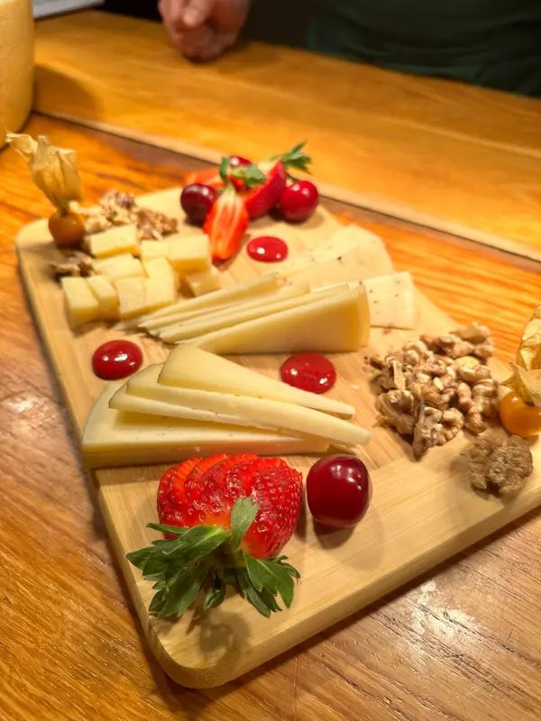 Cheese board with walnuts, strawberries, cherries and physalis