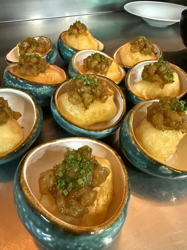 Fritters with a glossy topping served in blue ceramic bowls
