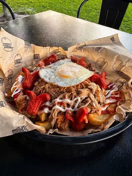 Monster Beast Salchipapa with a fried egg