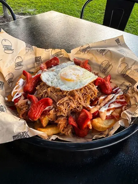Pulled Pork Salchipapa with a fried egg